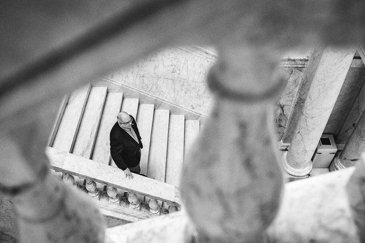 A picture Larry Hogan descending the staircase at the the state house.
