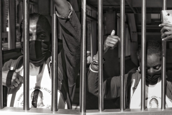  Darlene Cain—whose son, Dale Graham, was killed by Baltimore City police in 2008—behind the bars of a train station at a recent youth protest.

Photography by Matthew Pasley